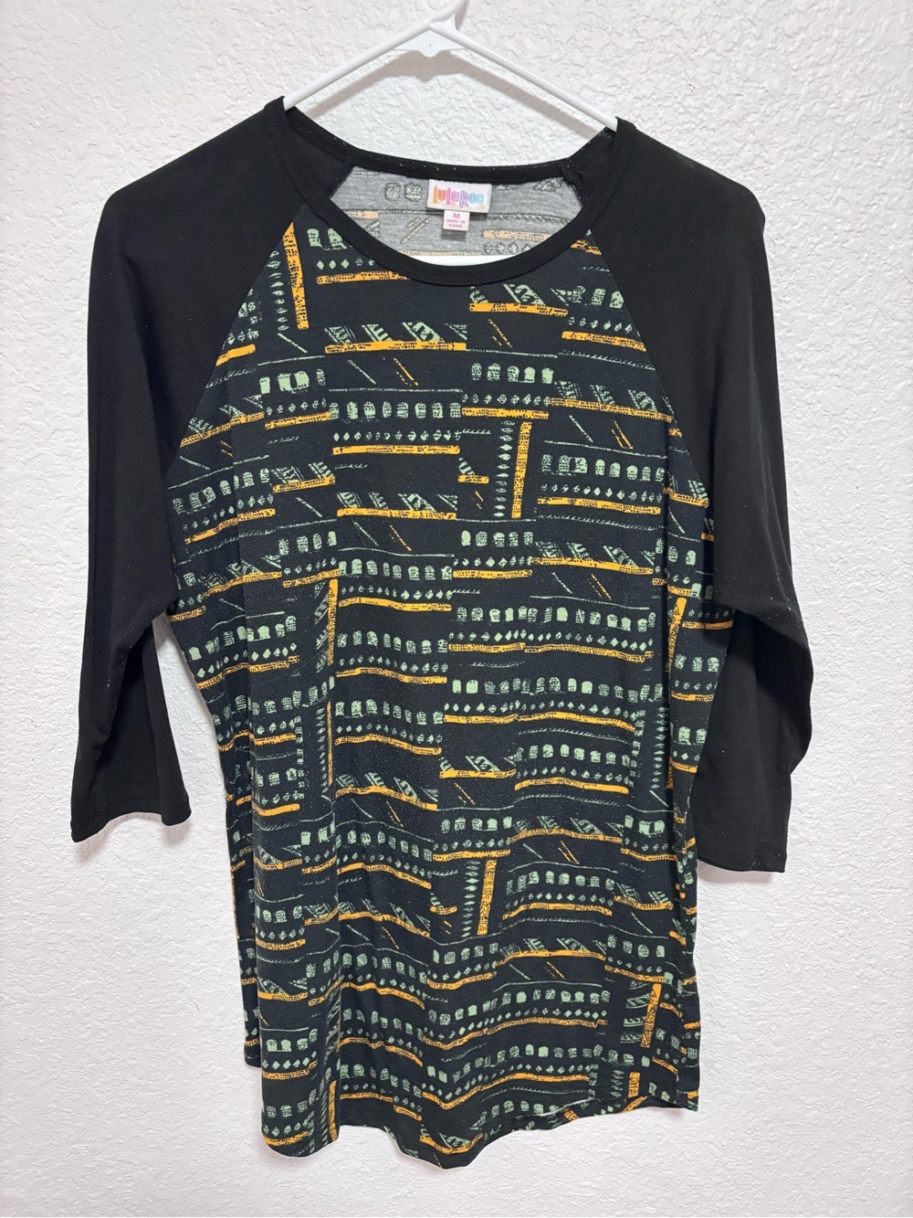 LuLaRoe Black Raglan Top with Green & Gold Geometric Print